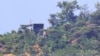 11일 북한 확성기로 추정되는 시설이 남북간 비무장지대(DMZ) 인근 강화도에서 바라본 북한 언덕 꼭대기에 보인다.