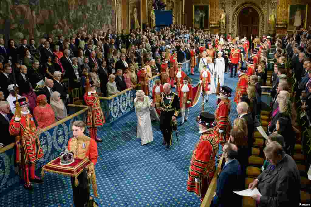Britain's Queen Elizabeth and Charles, the Prince of Wales proceed through the Royal Gallery before the Queen's Speech during the State Opening of Parliament at the Palace of Westminster in London.