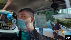 資料照：香港首位被控涉嫌違反國安法的男子唐英傑（Tong Ying-kit）坐著輪椅由警車押解至法院應訊。 （2020年7月6日）