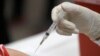 FILE - This Jan. 23, 2020 file photo shows a patient receiving a flu vaccination in Mesquite, Texas.