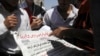 Members of the Muslim Brotherhood and supporters of ousted Egyptian President Mohamed Morsi read the Al Ahram newspaper's front page reading, "Public Prosecutor Hesham Barakat had ordered the detention of ousted President Mohamed Mursi for 15 days pending