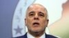FILE - Shiite lawmaker and Deputy Parliament Speaker Haider al-Abadi speaks to the media after an Iraqi parliament session in Baghdad.