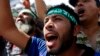 Supporters of Egyptian President Mohamed Mursi shout slogans during a protest around the Raba El-Adwyia mosque square in the suburb of Nasr City, Cairo, June 28, 2013.