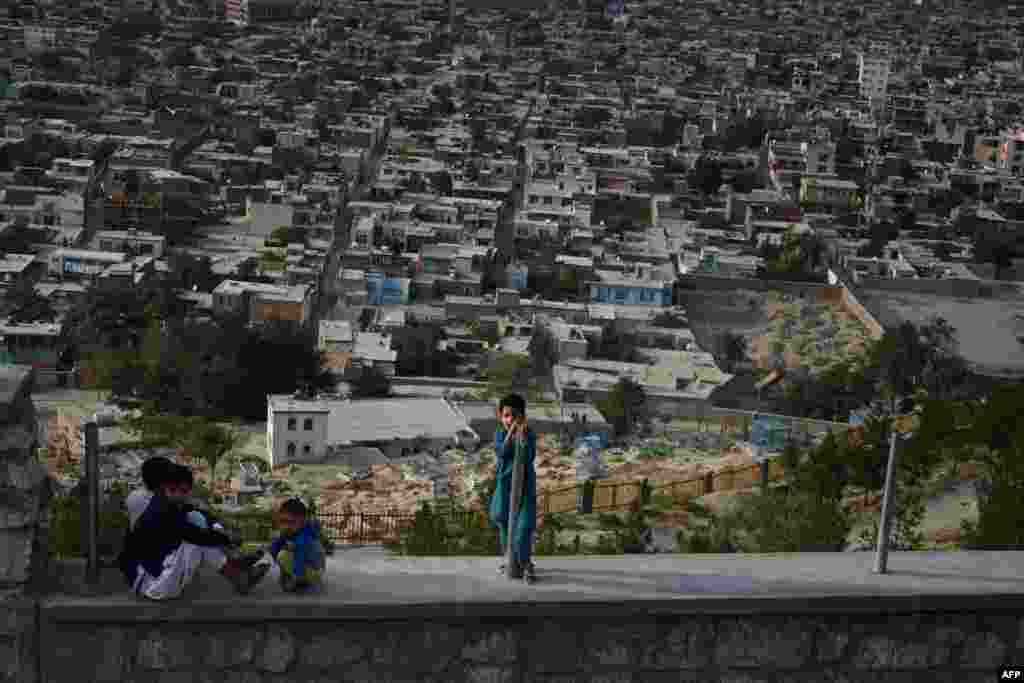 Children sit on a path at Wazir Akbar Khan hilltop overlooking Kabul, Afghanistan.