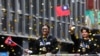 資料照：2024年11月26日，在台北，台灣棒球隊隊長陳傑憲(右)和球員林家正在慶祝球隊贏得2024WBSC十二強棒球錦標賽冠軍的遊行中向人群揮手致意。 （法新社）