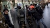 A photographer takes photos of an opposition supporter during a march toward parliament in Kyiv, Ukraine, Feb. 6, 2014.