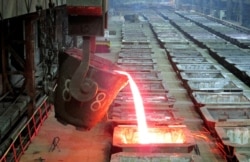 FILE - Molten nickel is poured at the Norilsk Nickel company's Nadezhda Metallurgical Plant in the Arctic city of Norilsk, Jan. 23, 2015.