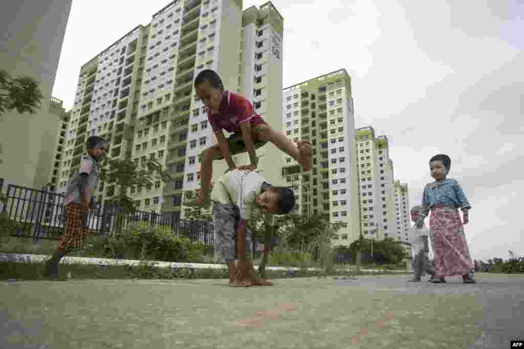Children play near an apartment complex on the outskirts of Yangon, Myanmar.