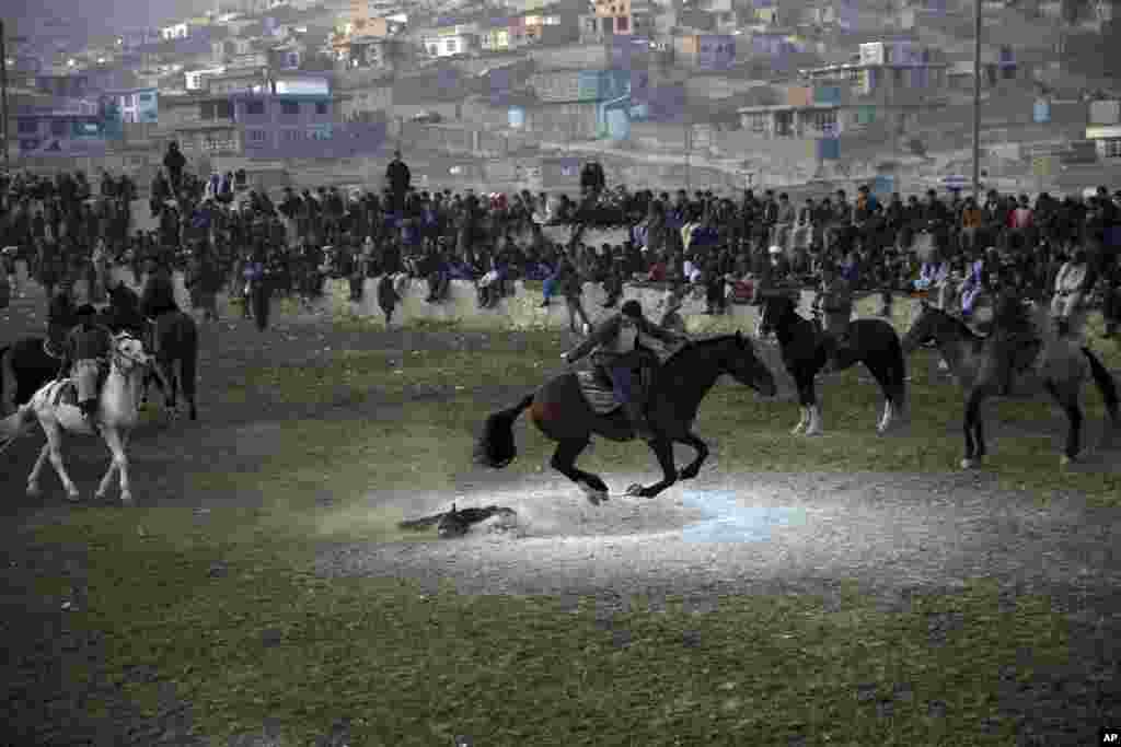 Afghan horse riders compete for the goat during a friendly buzkashi match on the outskirts of Kabul, Afghanistan.