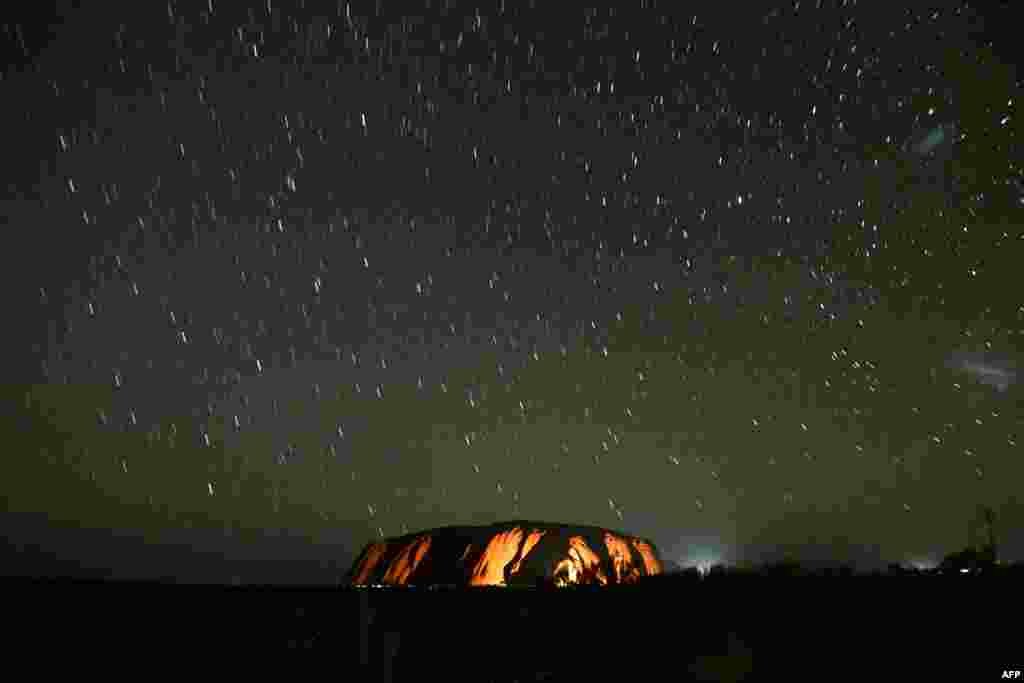 Stars trails are seen over Uluru, also known as Ayers rock, after a permanent ban on climbing the monolith at the Uluru-Kata Tjuta National Park in Australia's Northern Territory, Oct. 26, 2019. Uluru was permanently closed to climbers to meet the wishes of Aboriginal people who hold the red monolith sacred.