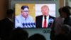 People watch a TV screen showing President Donald Trump, right, and North Korean leader Kim Jong Un during a news program at the Seoul Railway Station, April 21, 2018. North Korea said it has suspended nuclear and long-range missile tests and plans to close its nuclear test site.