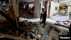 Palestinians check a house damaged during an Israeli raid, in Balata camp, Nablus, in the Israeli-occupied West Bank, May 22, 2023.