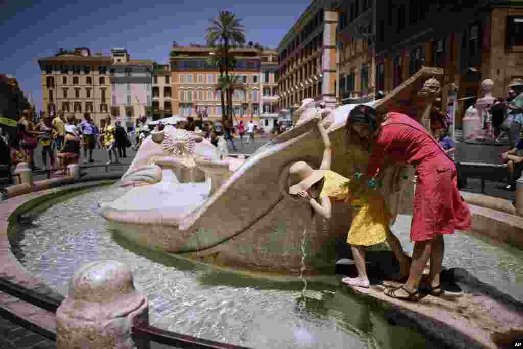 People drink from Italian 17th Century sculptor Bernini's Barcaccia fountain, in Rome. City hall announced that Mayor Virginia Raggi had signed an ordinance aimed at protecting some 40 fountains of historic or artistic interest to try to protect the monumental works, not infrequently trashed by tourists, sports fans and Romans.