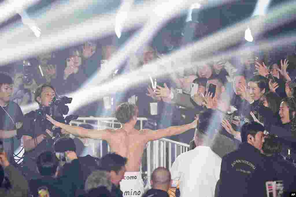 Fans cheer as Japanese champion Naoya Inoue leaves the ring after defending his unified WBC IBF and WBO super bantamweight world title at the Ariake Arena in Tokyo. (AP Photo/Hiro Komae)