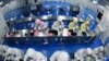 FILE PHOTO: Employees work on a production line manufacturing camera lenses for cellphones at a factory in Lianyungang, Jiangsu province, China April 30, 2019. 