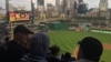 M. Kazam Hashimi and his family, refugees from Afghanistan, attend Hello Neighbor’s Refugee and Immigrant Night at PNC Park, Aug. 1, 2017, with their American mentor Michelle Boehm and her family in Pittsburgh.
