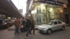 People walk past a foreign currency exchange spot in Cairo (file photo).