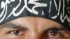 A Free Syrian Army fighter wears a headband reading the Islamic declaration of faith, "There is no God but God, and Mohammed is His Messenger", in central Aleppo August 9, 2012. 
