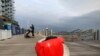 FILE - A cargo-carrying robot called the Gita sits near a waterfront park on Nov. 11, 2019, in Boston.