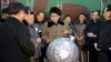 김정은 북한 국방위원회 제1위원장이 핵무기 연구 부문 과학자, 기술자들을 만나 핵무기 병기화 사업을 지도하는 모습을 지난달 9일 조선중앙통신이 보도했다. 사진 아래쪽에 핵탄두 기폭장치 추정 물체가 보인다. (자료사진)