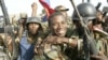 aitian National Revolutionary Liberation Front Commander-in-Chief, Guy Philippe, hugs other soldiers from the 