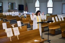 FILE - A pastor leads a virtual Sunday service online during the coronavirus pandemic, at Peace Lutheran church, in Burlington, North Dakota, April 26, 2020.
