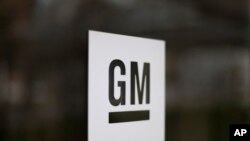 FILE - The General Motors logo at the company's world headquarters in Detroit.