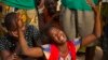A woman reacts near the dead body of her sister, who was killed during one of the latest incidents of sectarian violence in Bangui, Central African Republic, Feb. 9, 2014.