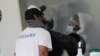 Rafael Ruiz, left, is tested for COVID-19 at a walk-up testing site during the coronavirus pandemic, July 17, 2020, in Miami Beach, Fla. 